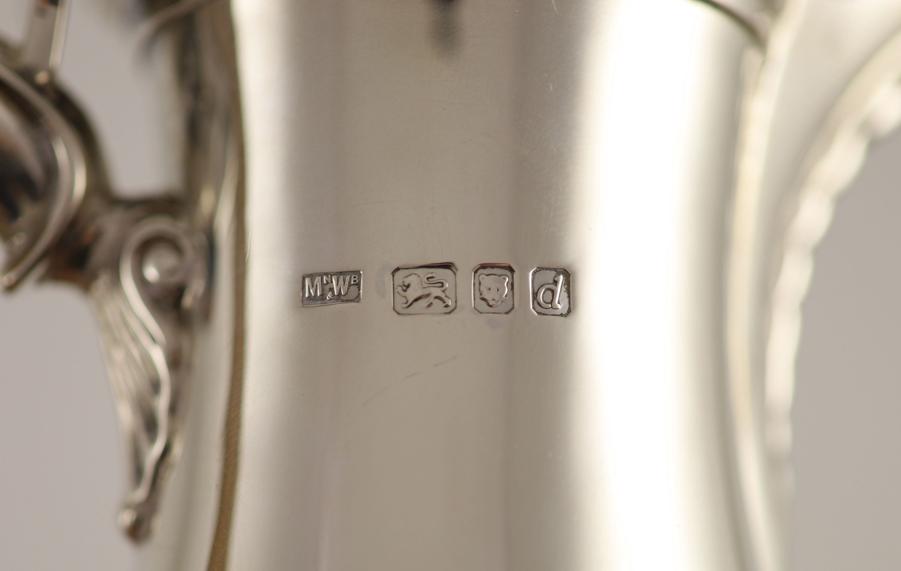 A Mappin & Webb 18th century style silver coffee pot with wood handle and matching hot water jug,